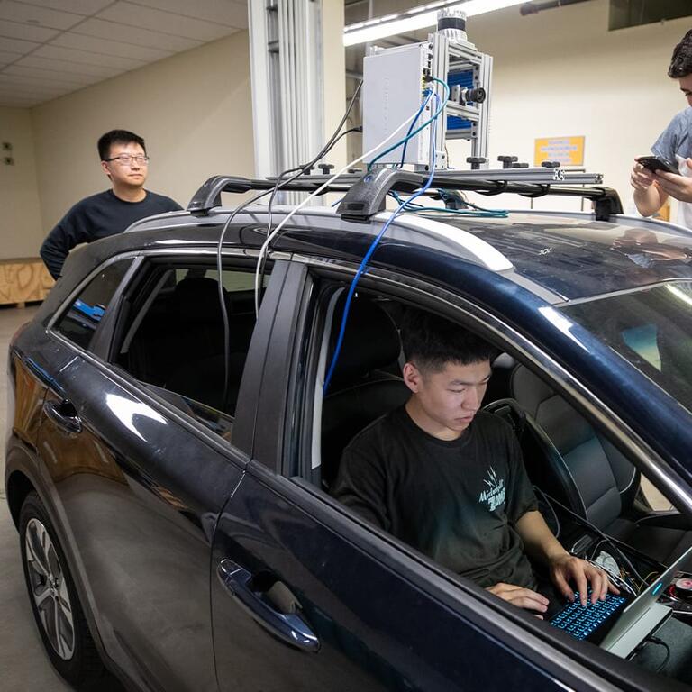 UCR robotics student using AI tools on a laptop computer.
