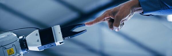 robot hand touching a human hand